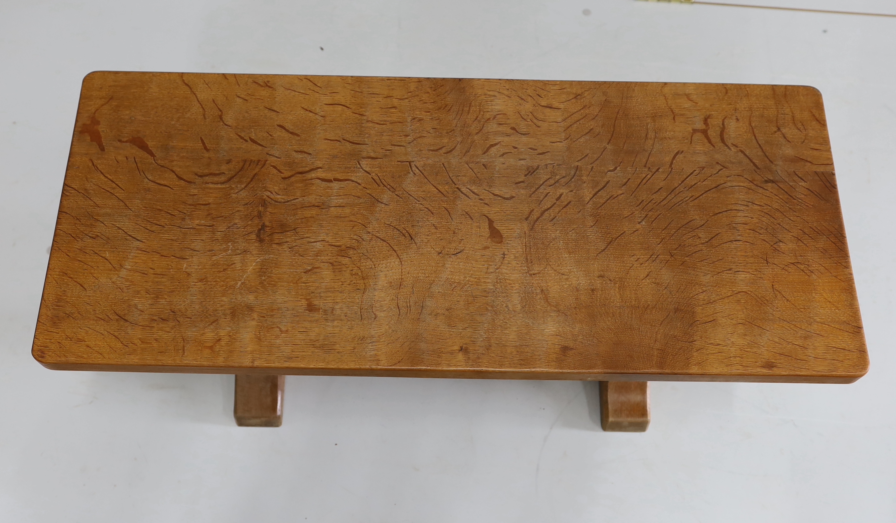 Robert Thompson, The Mouseman, a rectangular oak coffee table with adzed top on octagonal supports, width 91cm, depth 37cm, height 45cm